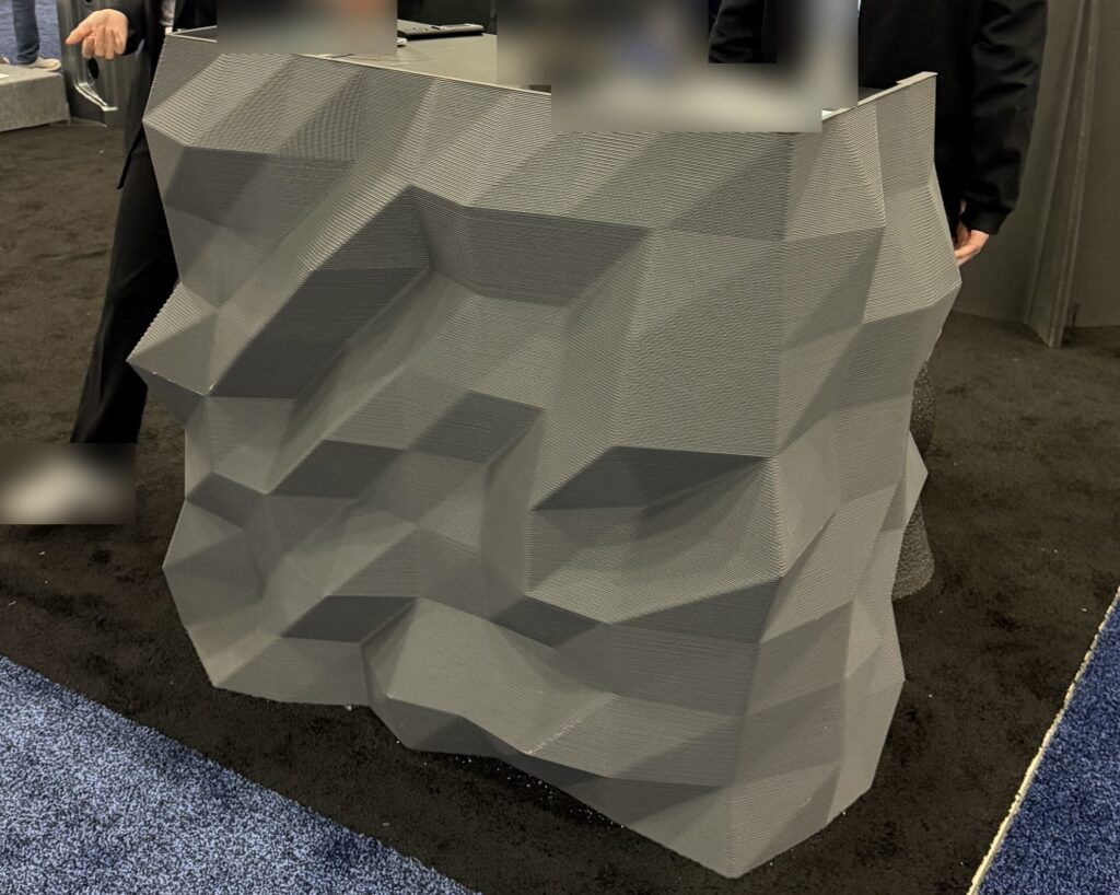 Large-format 3D printed faceted counter at an industry trade show